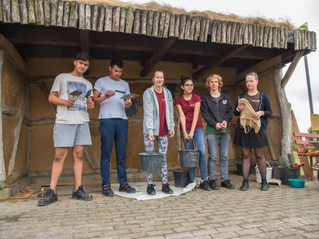 Die Teilnehmenden möchten loslegen. | Foto: Hendrik Silbermann (ARTWORKs) Die Teilnehmenden stehen in der Bushaltestelle mit Werkzeug. | Foto: Hendrik Silbermann (ARTWORKs)