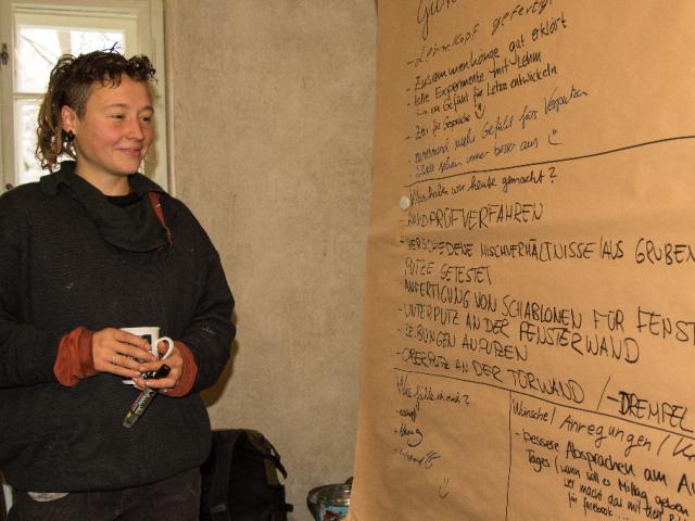 Das Tagesfeedback wird an die Pinnwand geschrieben. | Foto: Hendrik Silbermann (ARTWORKs) Eine Teilnehmerin schreibt ihr Tagesfeedback an eine Pinnwand. | Foto: Hendrik Silbermann (ARTWORKs)